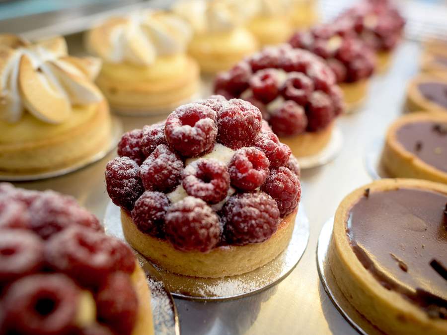 Rows of raspberry and chocolate tarts 