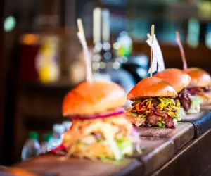 Several pork slider sandwiches getting ready to be served