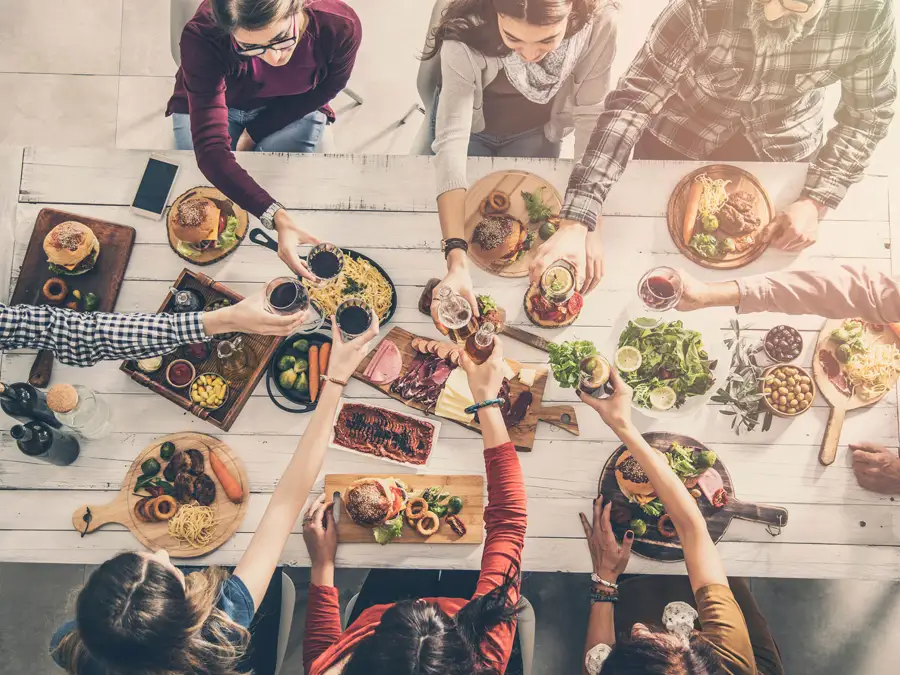 A group of diners raising their glasses to toast