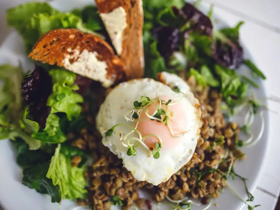 Fried egg over a green salad